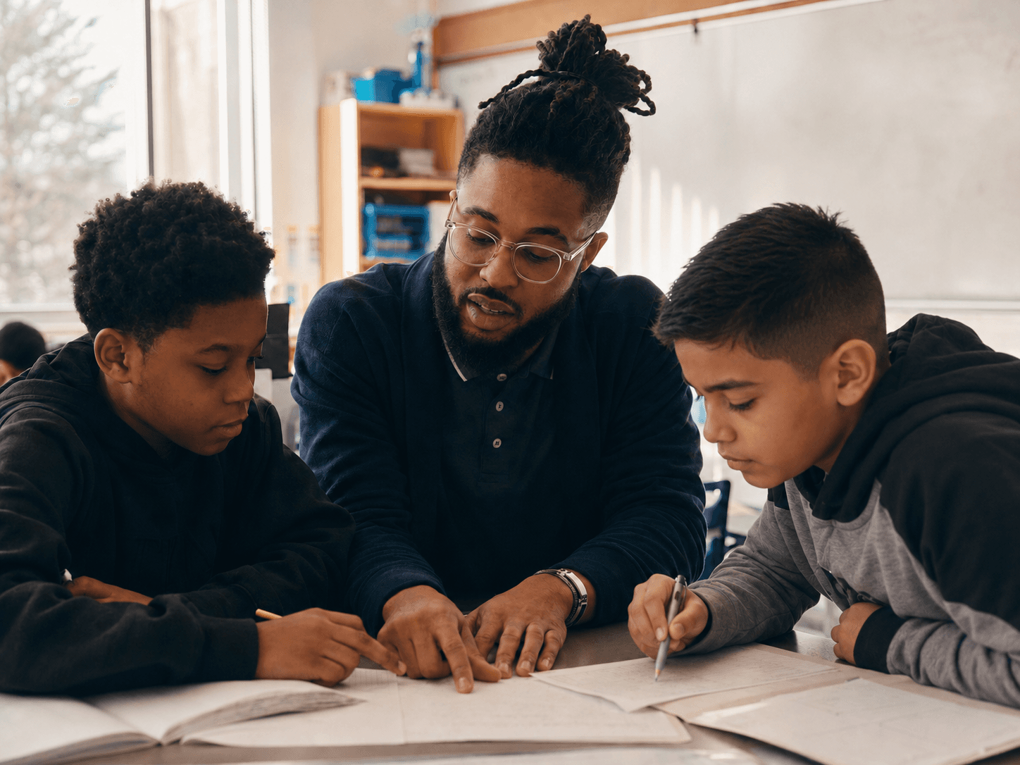 Educator working with boys in a structured classroom