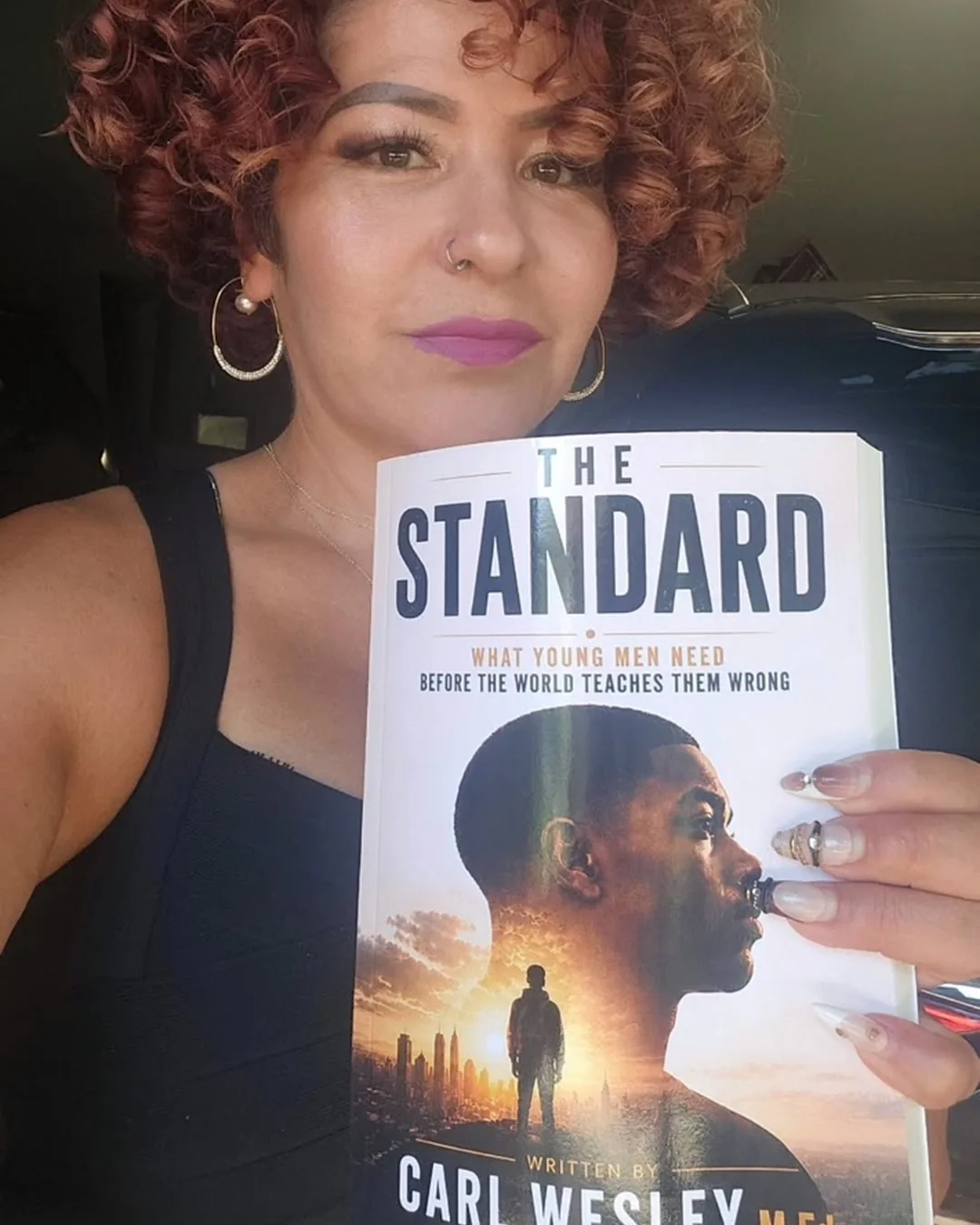 Reader holding The Standard by Carl Wesley 06