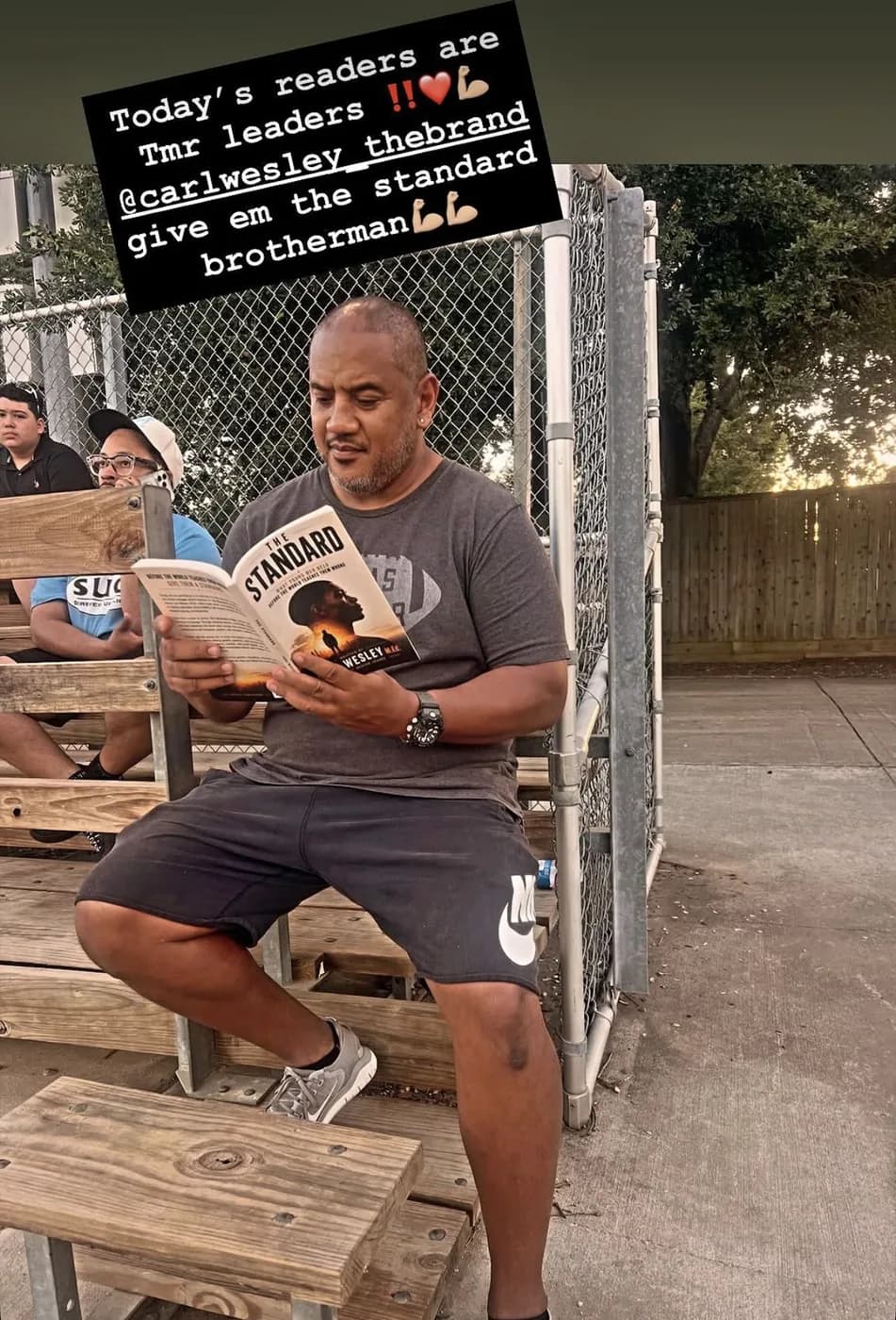 Reader holding The Standard by Carl Wesley 08
