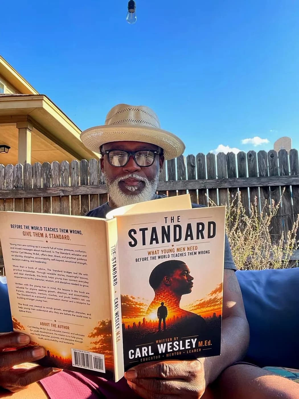 Reader holding The Standard by Carl Wesley 12