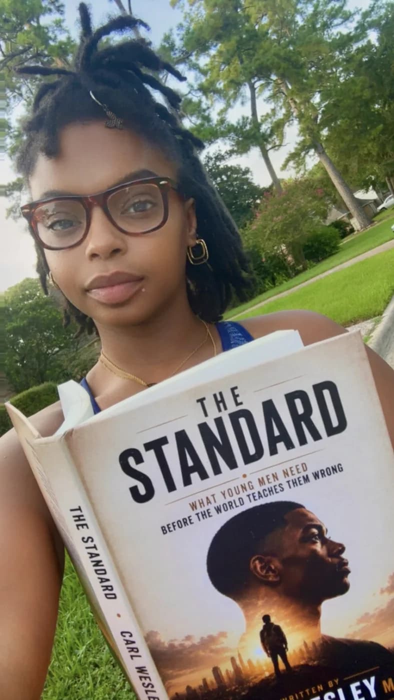 Reader holding The Standard by Carl Wesley 17