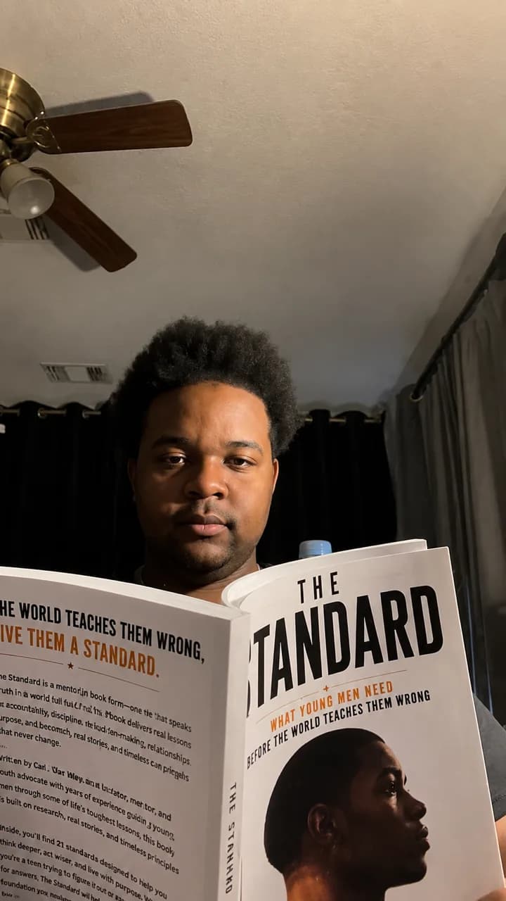 Reader studying The Standard by Carl Wesley